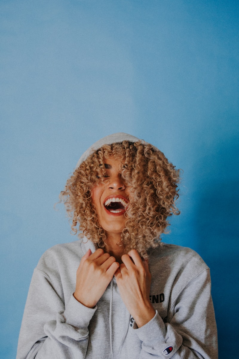 Photo by Ivana Cajina smiling woman wearing gray hoodie